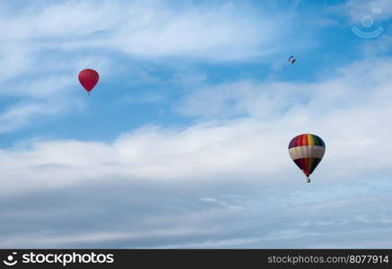 Multicolored Balloons in the blue cloudy sky