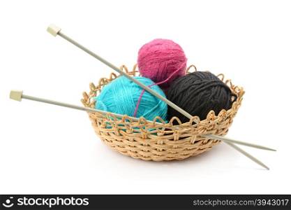 Multicolored balls and needles in basket isolated on white