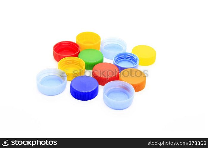 Multicolored caps from plastic bottles isolated on white background