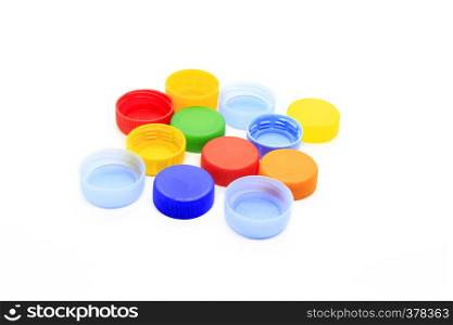 Multicolored caps from plastic bottles isolated on white background