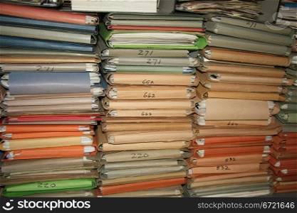 Multicolored cardboard files containing loads of paperwork