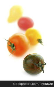 Multicolored cherry tomatoes isolated on white background