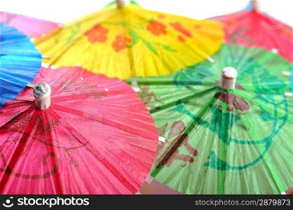 Multicolored cocktail umbrellas as background