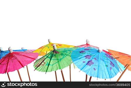 Multicolored cocktail umbrellas on white