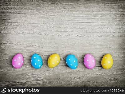 multicolored easter eggs on vintage wooden background