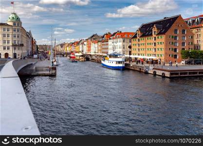 Multicolored facades of old medieval houses and ships along the canal of Nyhavn. Denmark.. Copenhagen. The Nyhavn channel.