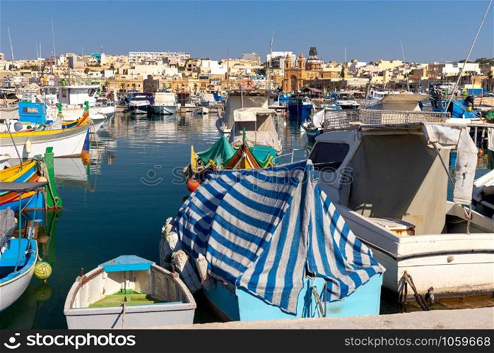 Multicolored fishing boats Luzzu with eyes in the harbor. Marsaxlokk. Malta.. Marsaxlokk. Traditional boats Luzzu in the old harbor.