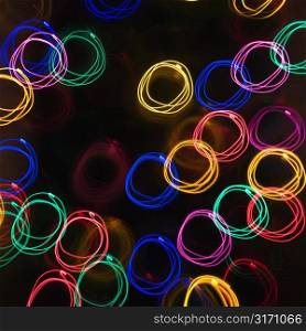 Multicolored lights forming abstract circle pattern from motion blur.