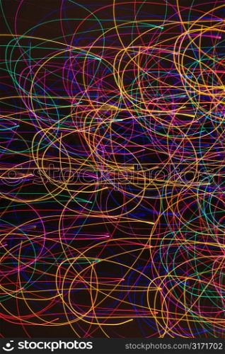 Multicolored lights forming abstract circular pattern from motion blur.