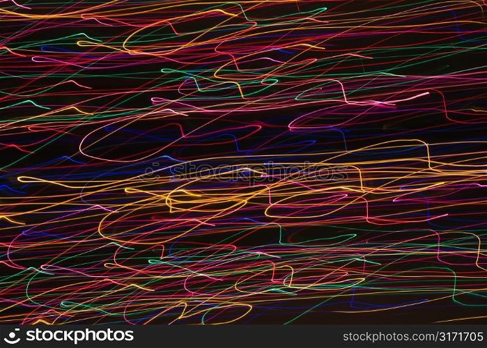 Multicolored lights forming abstract squiggle pattern from motion blur.