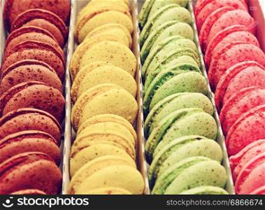 Multicolored macaroons in a paper box, selective focus