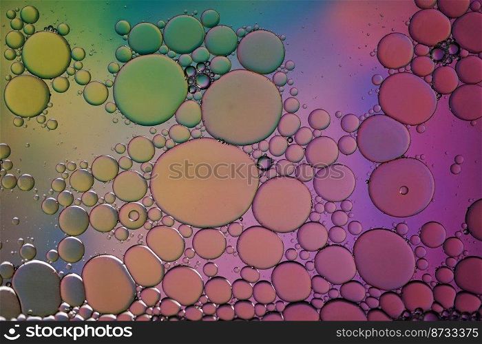 multicolored oil circles on the water, abstract background