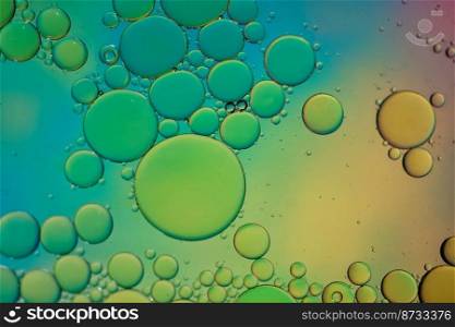 multicolored oil circles on the water, abstract background