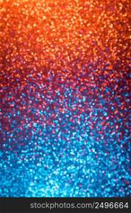 Multicolored orange red and blue shiny abstract blurred festive bokeh lights vertical background