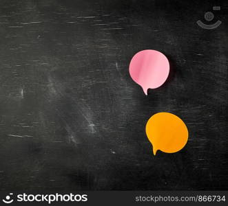 multicolored paper stickers on a black background in the shape of a cloud, copy space