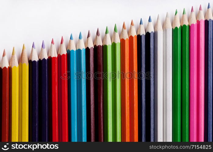 Multicolored pencils on a white background, the concept of business growth, learning. Creative ideas.. Multicolored pencils on a white background, the concept of business growth, learning.