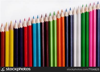 Multicolored pencils on a white background, the concept of business growth, learning. Creative ideas.. Multicolored pencils on a white background, the concept of business growth, learning.