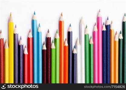 Multicolored pencils on a white background, the concept of business growth, learning. Creative ideas.. Multicolored pencils on a white background, the concept of business growth, learning.