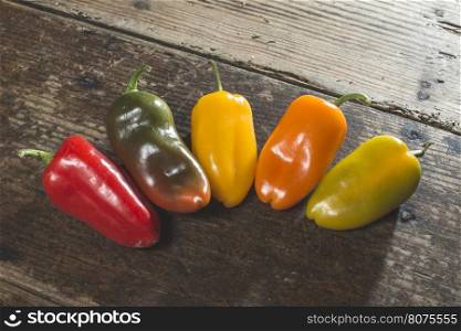 Multicolored peppers on wood