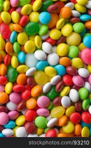 Multicolored round candies. Backgrounds and textures: a lot of multicolored round candies, confectionery abstract