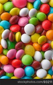 Multicolored round candies. Backgrounds and textures: a lot of multicolored round candies, confectionery abstract