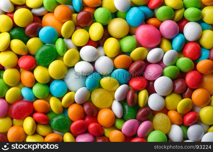 Multicolored round candies. Backgrounds and textures: a lot of multicolored round candies, confectionery abstract