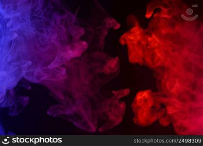 Multicolored smoke clouds flowing dark abstract background
