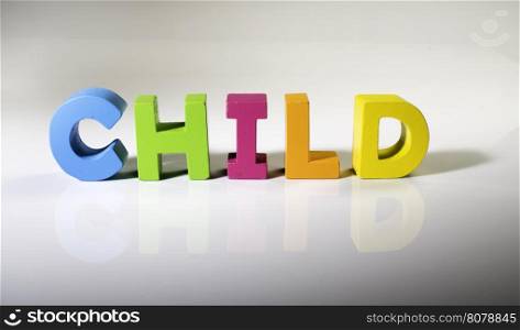 Multicolored text child made of wood. White background