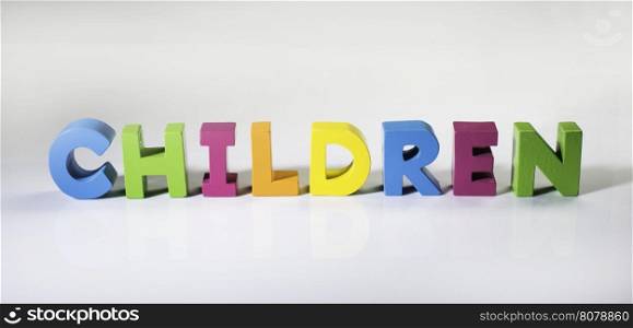 Multicolored text children made of wood. White background