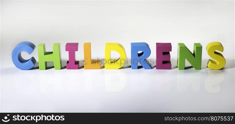 Multicolored text childrens made of wood. White background