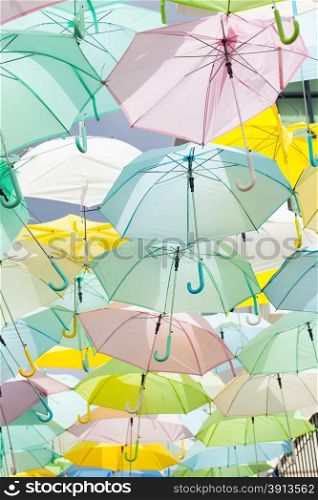 Multicolored umbrellas, sun umbrellas hanging colorful variety of the same size.
