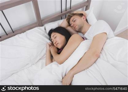 Multiethnic couple resting in bed