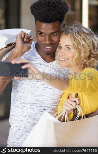 multiethnic couple taking selfie
