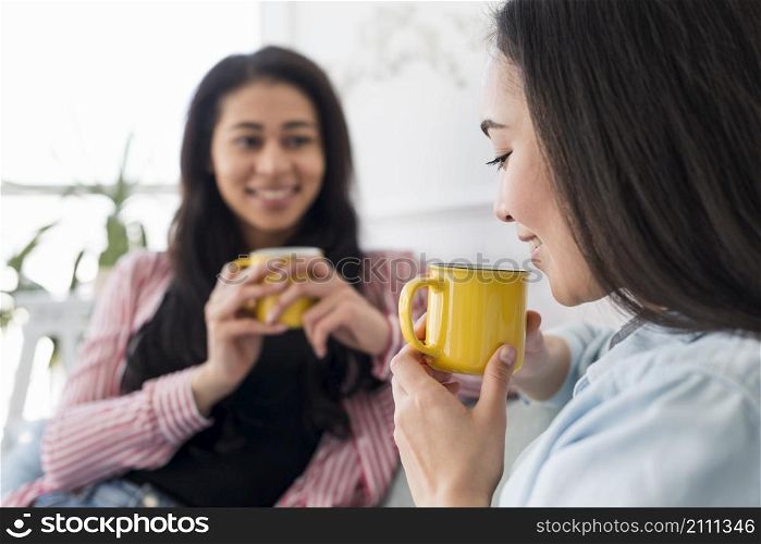 multiethnic girlfriends talking drinking tea