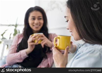 multiethnic girlfriends talking drinking tea