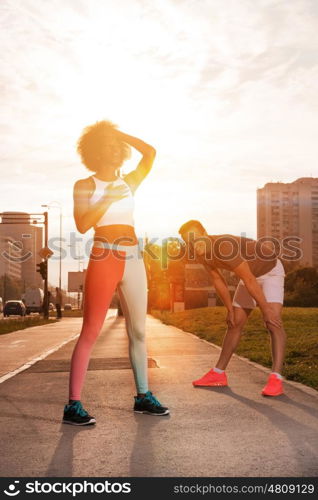 multiethnic group of young people on the jogging beautiful morning as the sun rises in the streets of the city