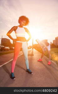 multiethnic group of young people on the jogging beautiful morning as the sun rises in the streets of the city