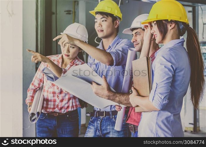 Multiethnic professional construction engineers working with Corporate Colleagues Teamwork and equipment blueprint at the building site place, Industrial engineering Concept