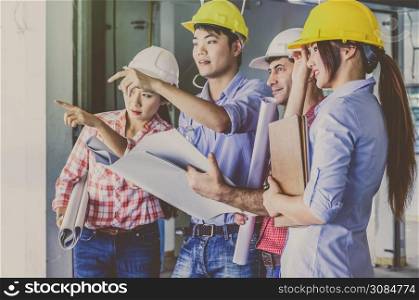 Multiethnic professional construction engineers working with Corporate Colleagues Teamwork and equipment blueprint at the building site place, Industrial engineering Concept