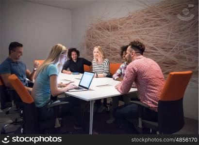 Multiethnic startup business team on meeting in modern bright office interior brainstorming, working on laptop and tablet computer