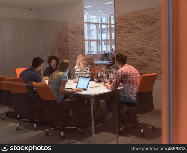 Multiethnic startup business team on meeting in modern bright office interior brainstorming, working on laptop and tablet computer