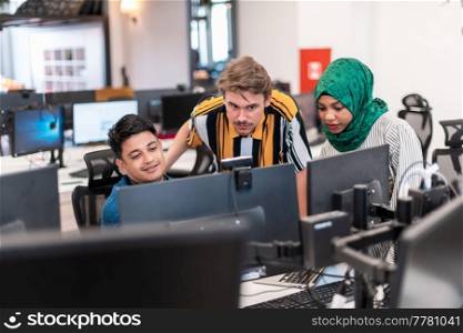 Multiethnic startup business team woman wearing a hijab on meeting in modern open plan office interior brainstorming, working on laptop and desktop computer. Selective focus. High-quality photo. Multiethnic startup business team woman wearing a hijab on meeting in modern open plan office interior brainstorming, working on laptop and desktop computer. Selective focus 