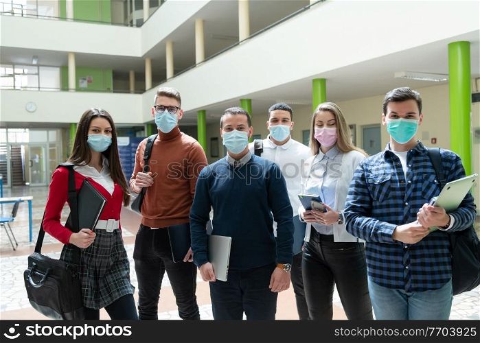 Multiethnic students group wearing protective face mask at university hallway new normal coronavirus time education concept