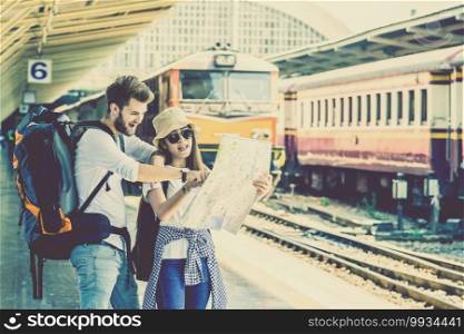 Multiethnic Travellers are looking at the map at the train station, Travel and transportation concept