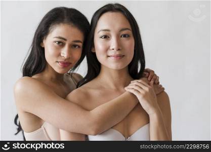multiethnic young women bras embracing