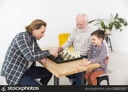 multigenerational men playing chess