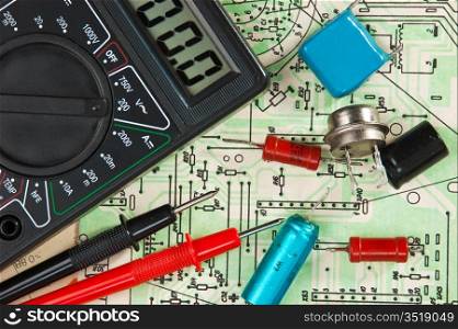 multimeter and electronic components on circuit