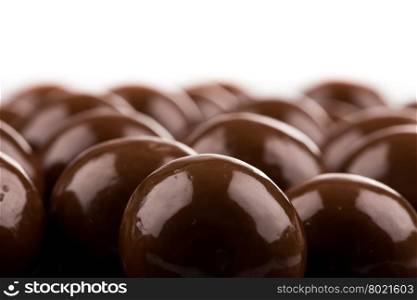 Multiple chocolate ball candies composition, isolated over the white background