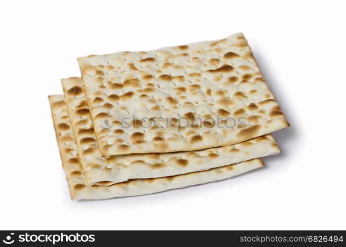 Multiple machine made matza flatbreads lying one over another, composition isolated over the white background