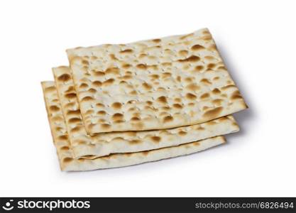 Multiple machine made matza flatbreads lying one over another, composition isolated over the white background